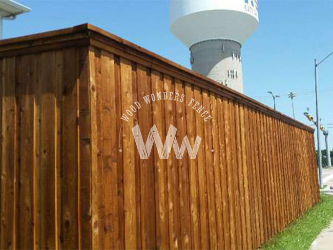 Stained cedar board-on-board fence with double trim built in North Texas