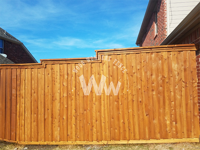 Cedar fence repaired along a sloped step-down property line